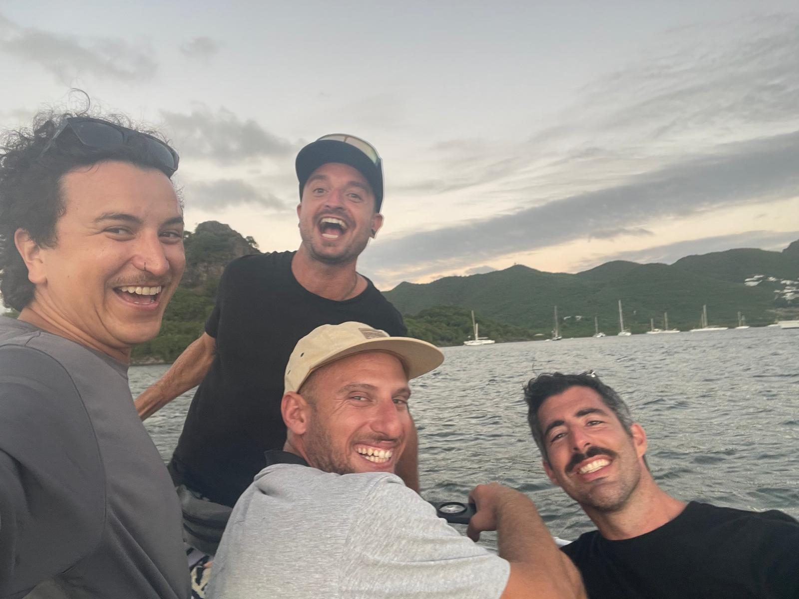 The four crew at sunset, at anchor on the far side of the Atlantic