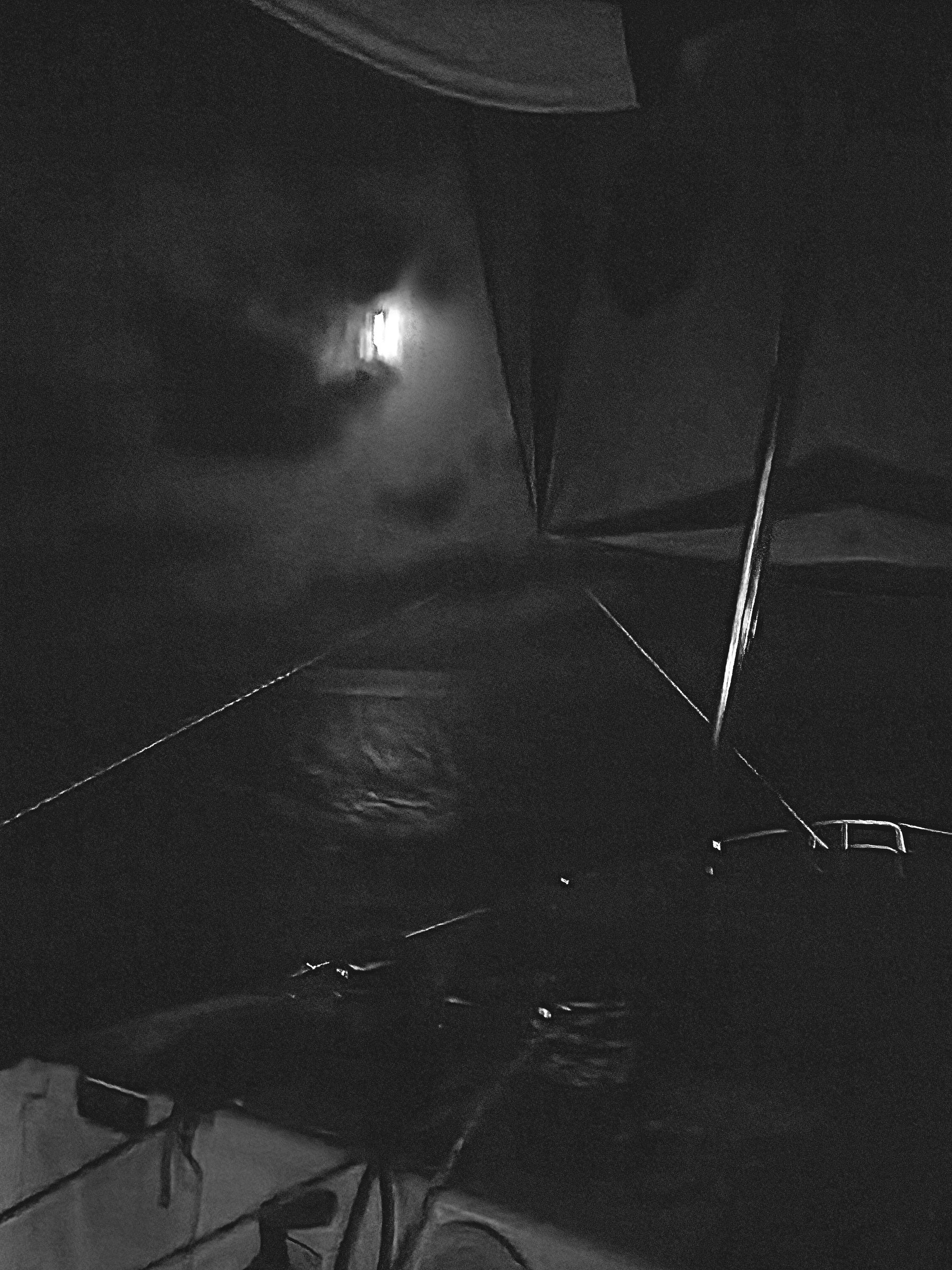 Sailing by night: the moon above the catamaran’s mainsail, seen from the cockpit