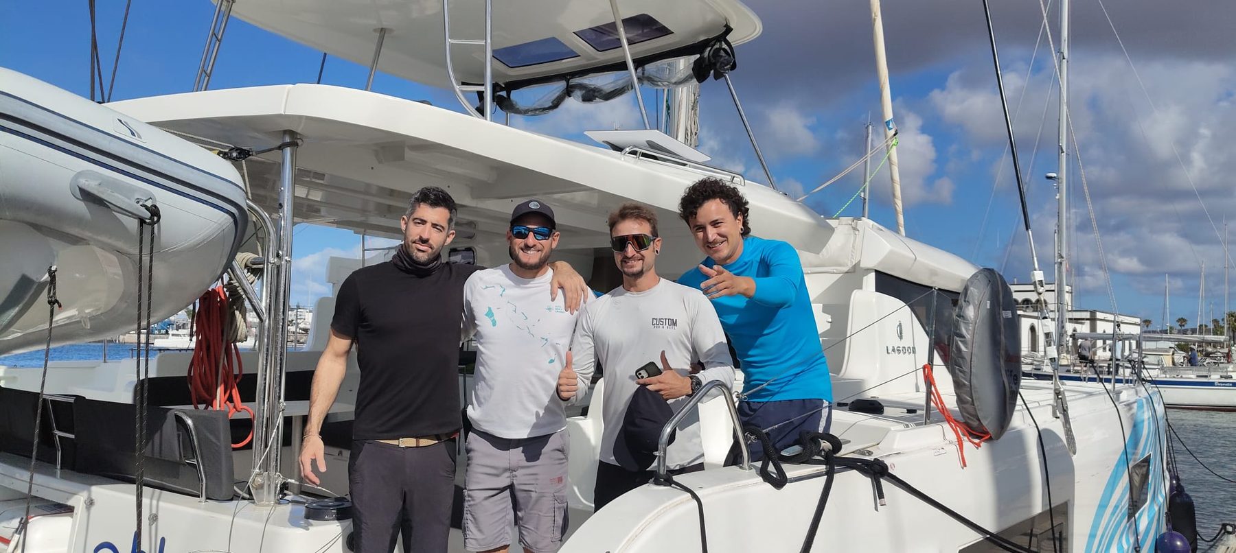The Lagoon 46's crew on the catamaran's bow, in port, before setting off across the Atlantic